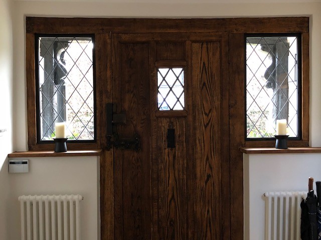 Black metal-frame windows surrounding the entrance to the property