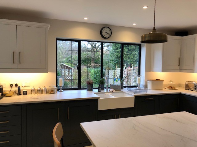 Extended kitchen featuring slimline black metal-frame windows